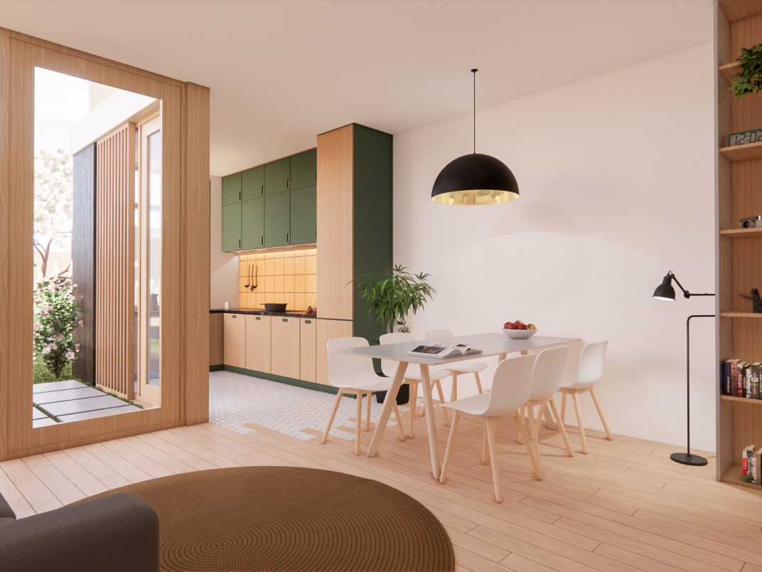Keuken aan de achterzijde met groene kasten en eettafel onder hanglamp